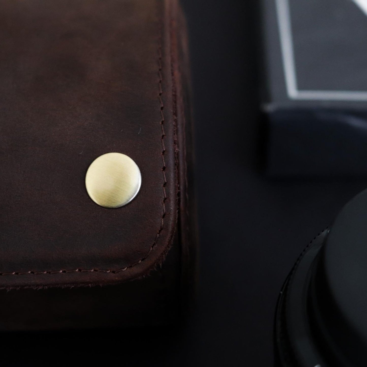 M and Son, leather watch roll, with a close up of the brass button.