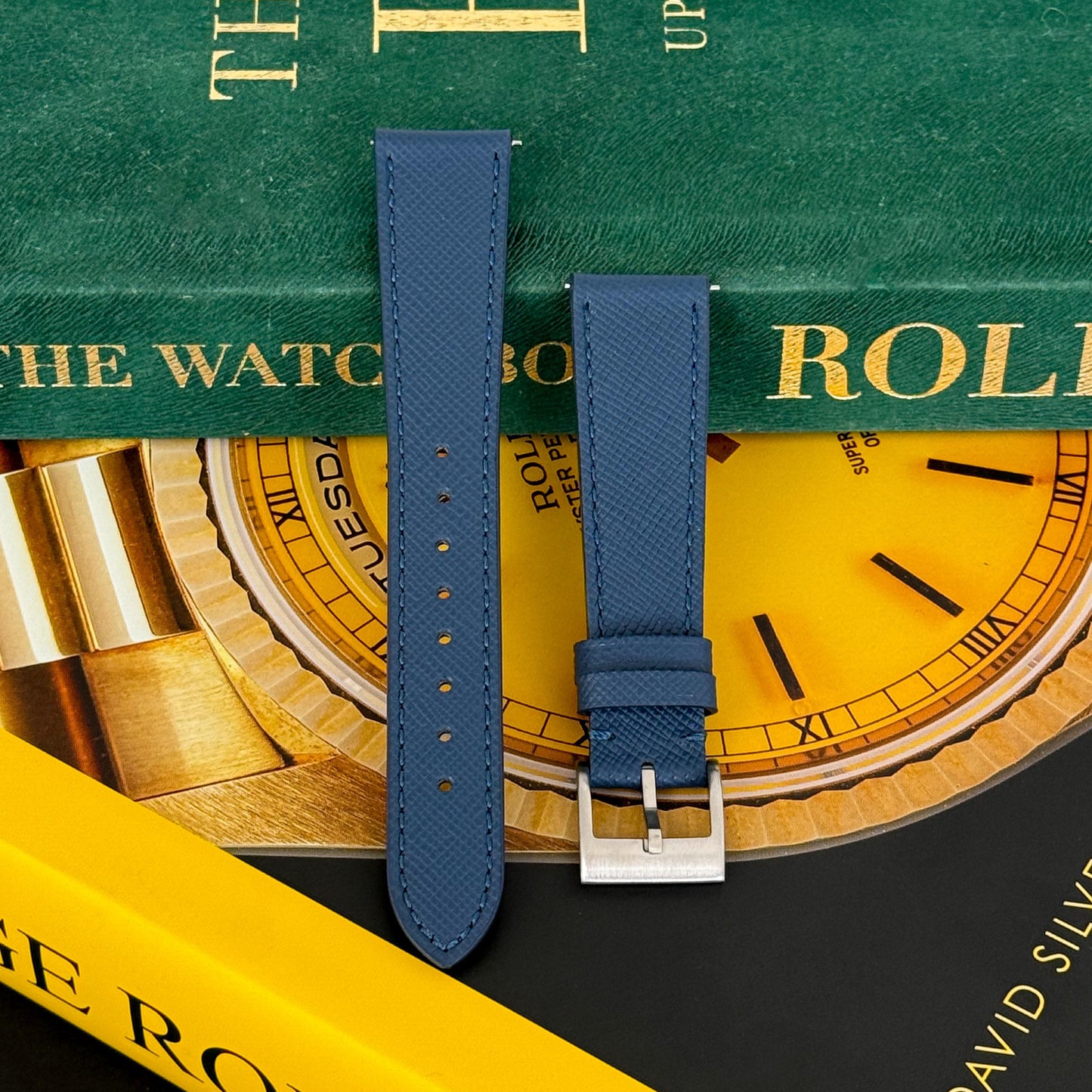 m and son leather watch strap resting on two rolex books