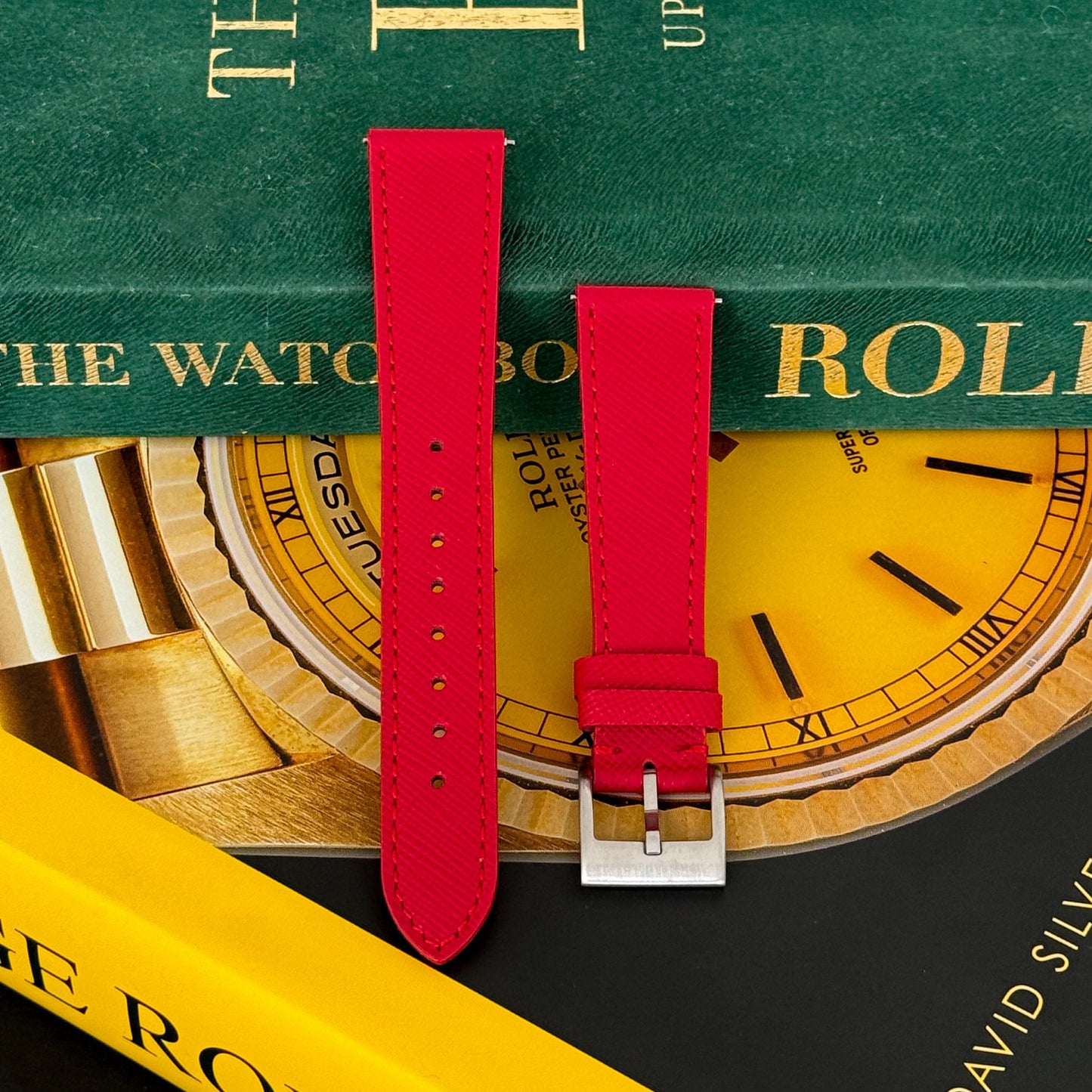 m and son leather watch strap resting on two rolex books