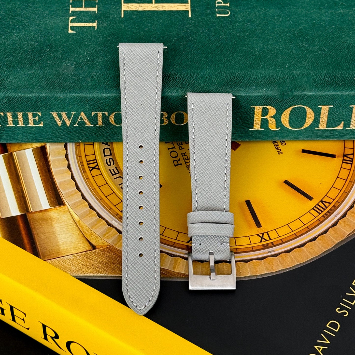 m and son leather watch strap resting on two rolex books