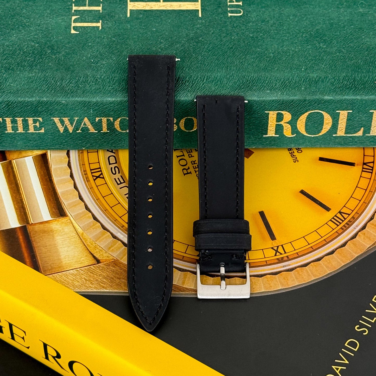 A black calf leather watch strap displayed on a surface with a focus on the texture and color, suitable for both casual and formal occasions.