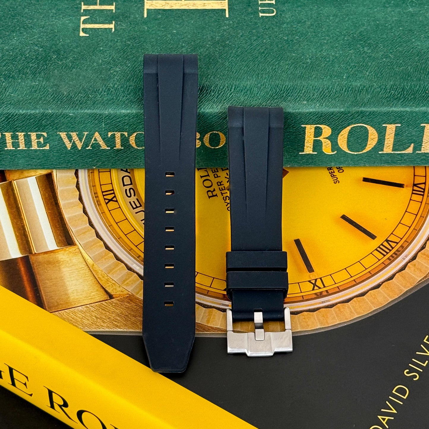 m and son fmk rubber watch strap resting on two rolex books