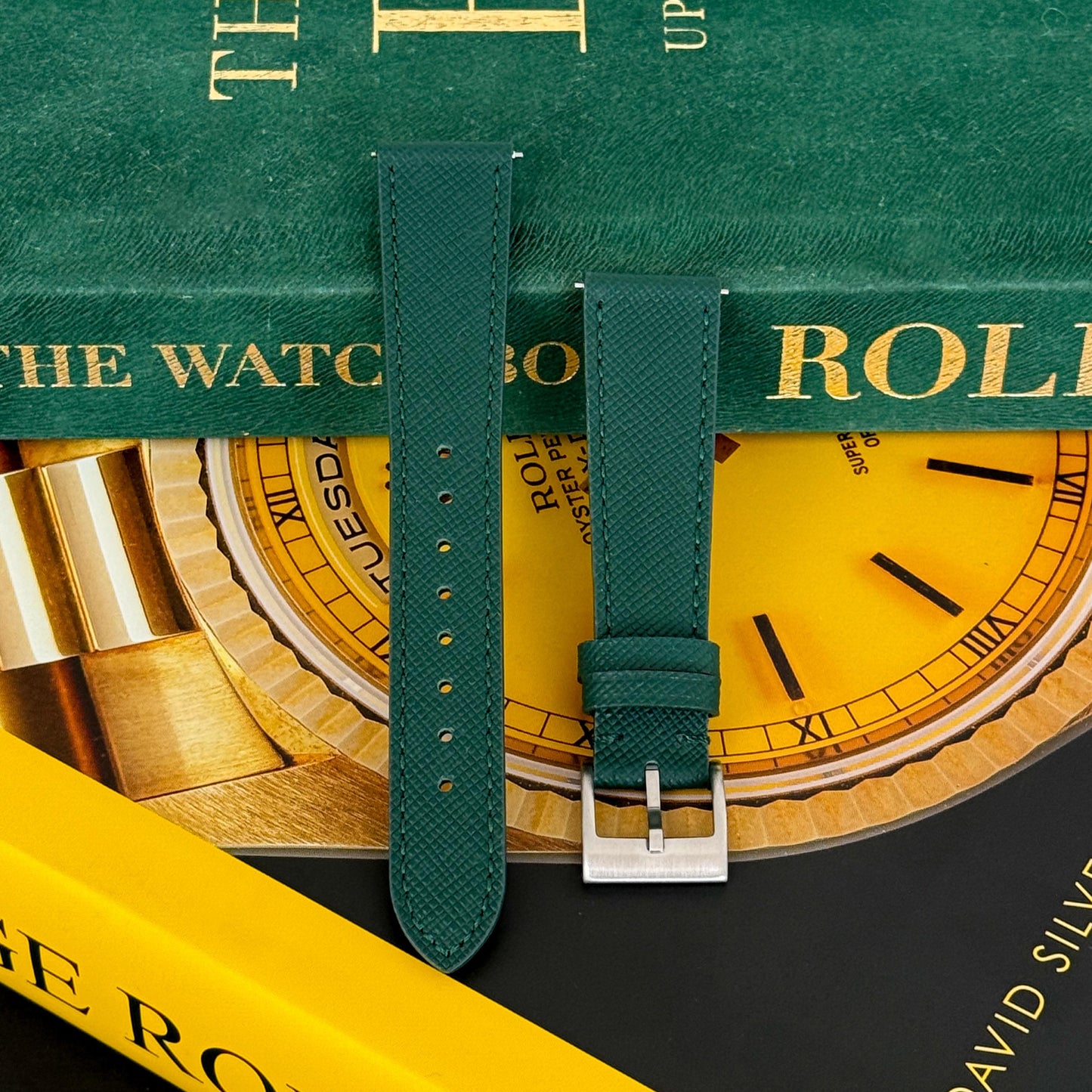 m and son leather watch strap resting on two rolex books