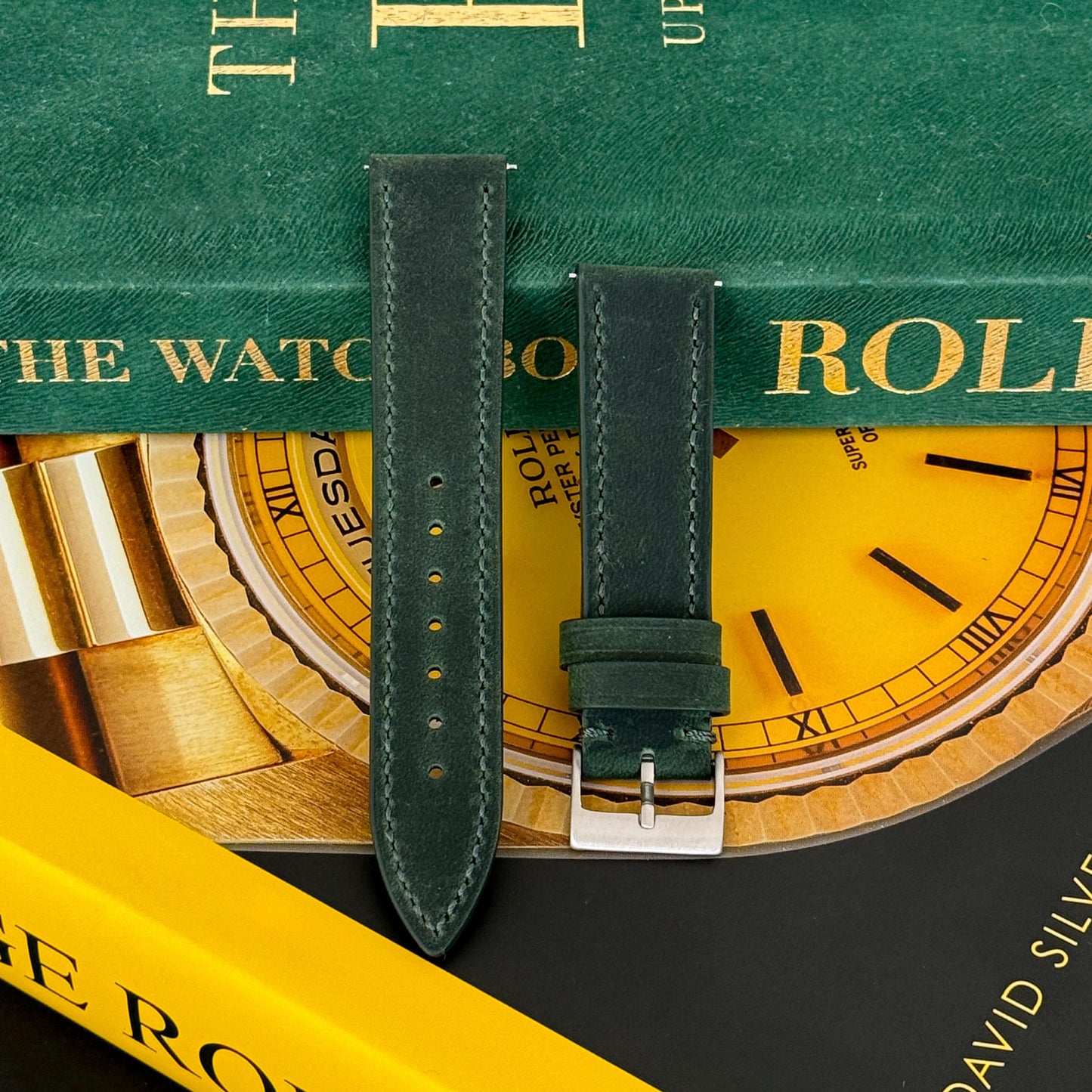 A moss green calf leather watch strap displayed on a watch with a silver buckle.