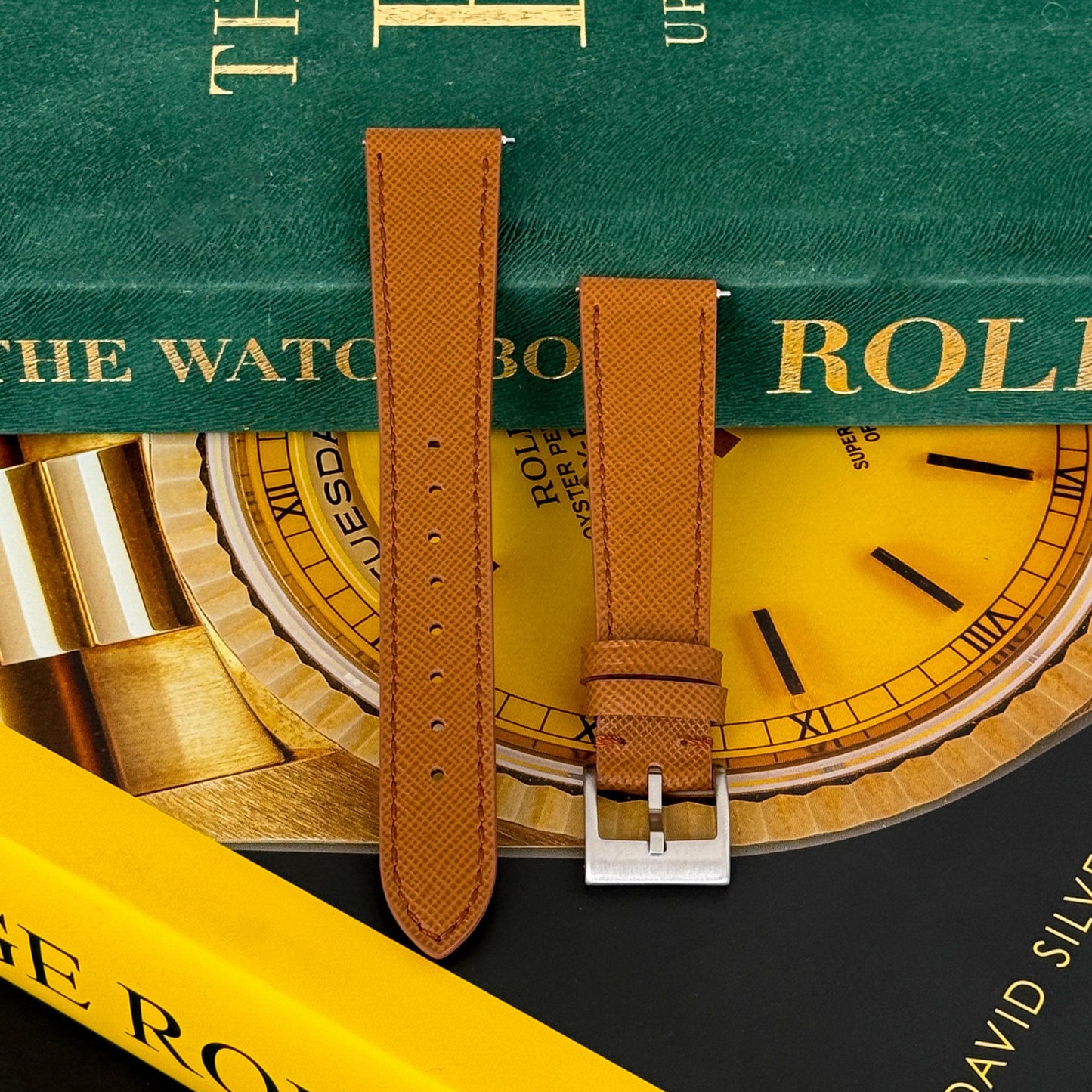 m and son leather watch strap resting on two rolex books