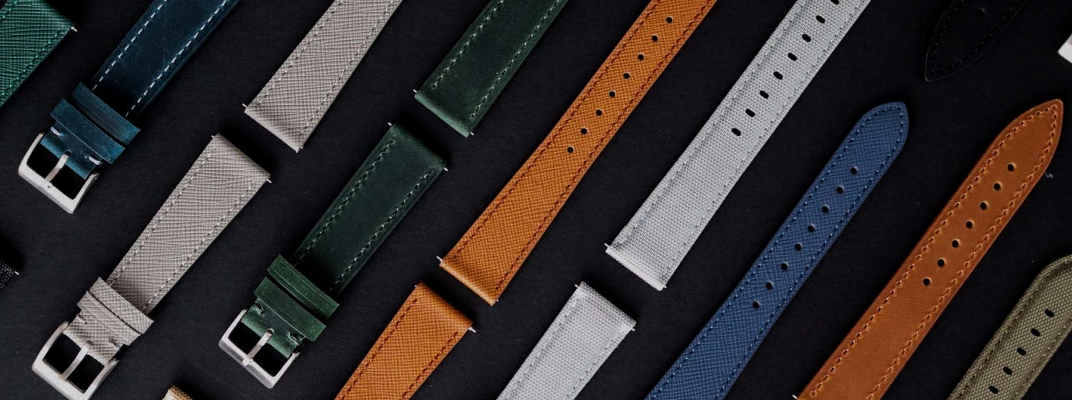 Collection of various m and son watch straps on a dark background