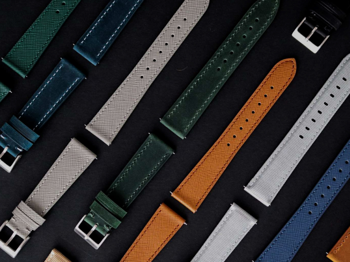 Collection of various watch straps on a dark surface