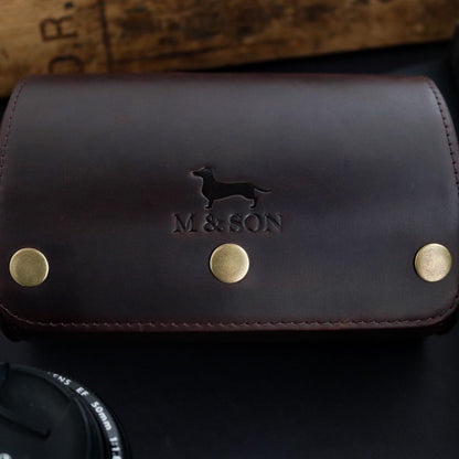 M and Son, double leather watch roll, front view of the embossed logo.