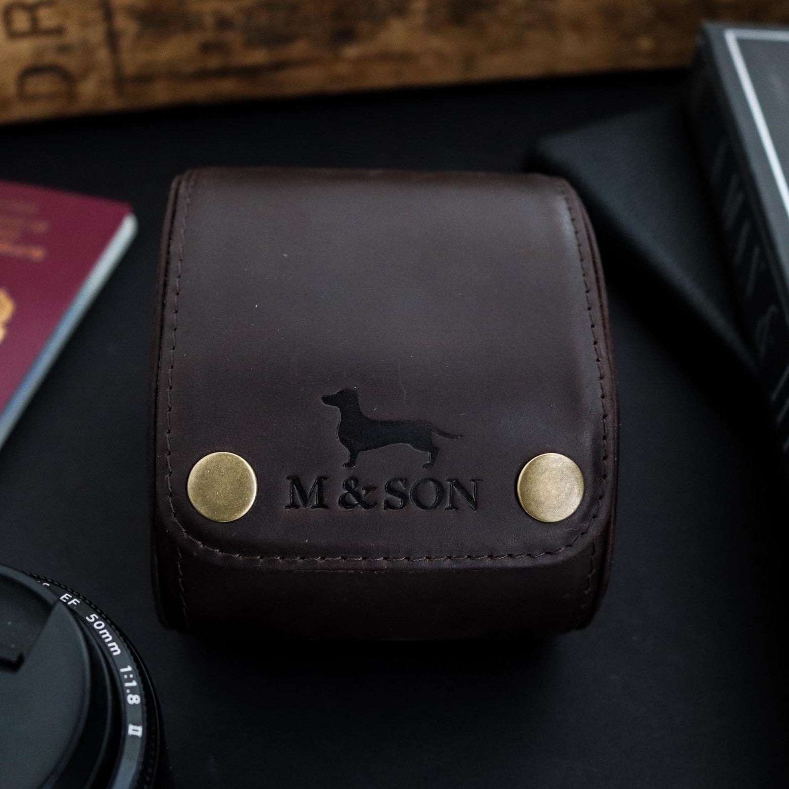 M and Son leather watch roll with a front view of the embossed logo.