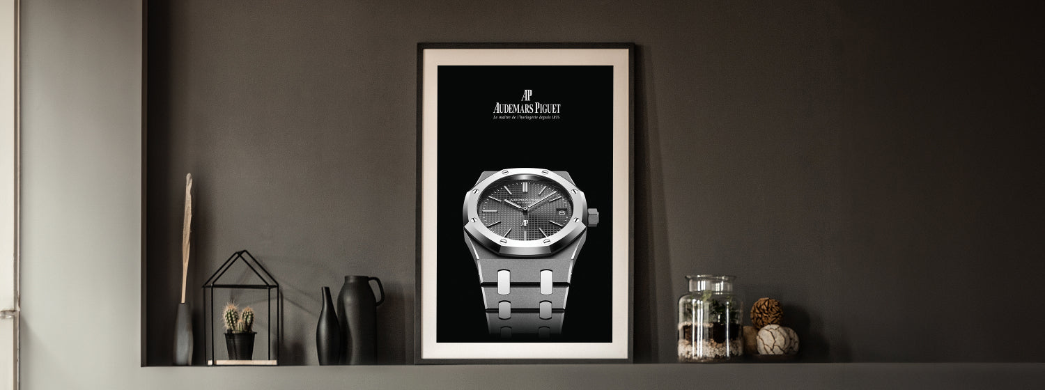 Framed poster of a audemars piguet watch on a dark wall with decorative items.