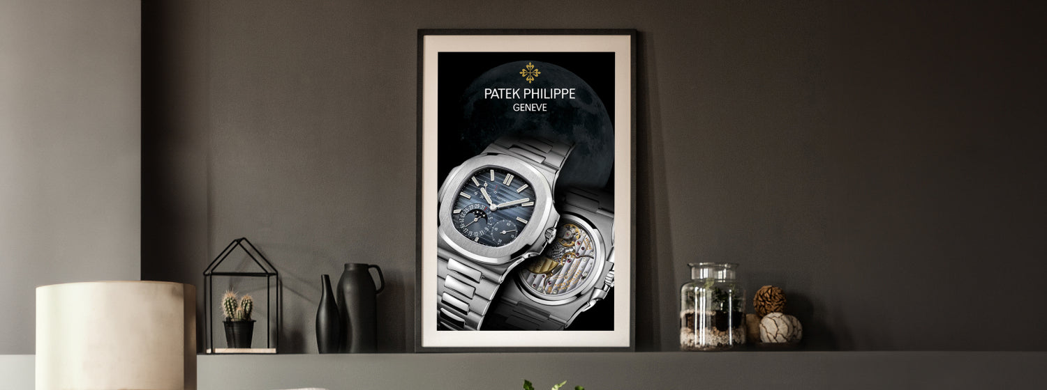 Framed Patek Philippe watch poster on a dark wall with decorative items.