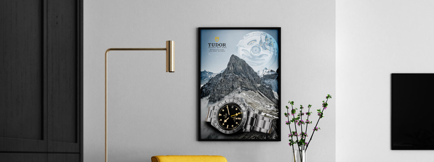Framed poster of a mountain landscape with a clock on a wall in a modern interior setting.