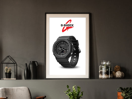 Framed G-Shock watch poster on a wall with decorative items below.
