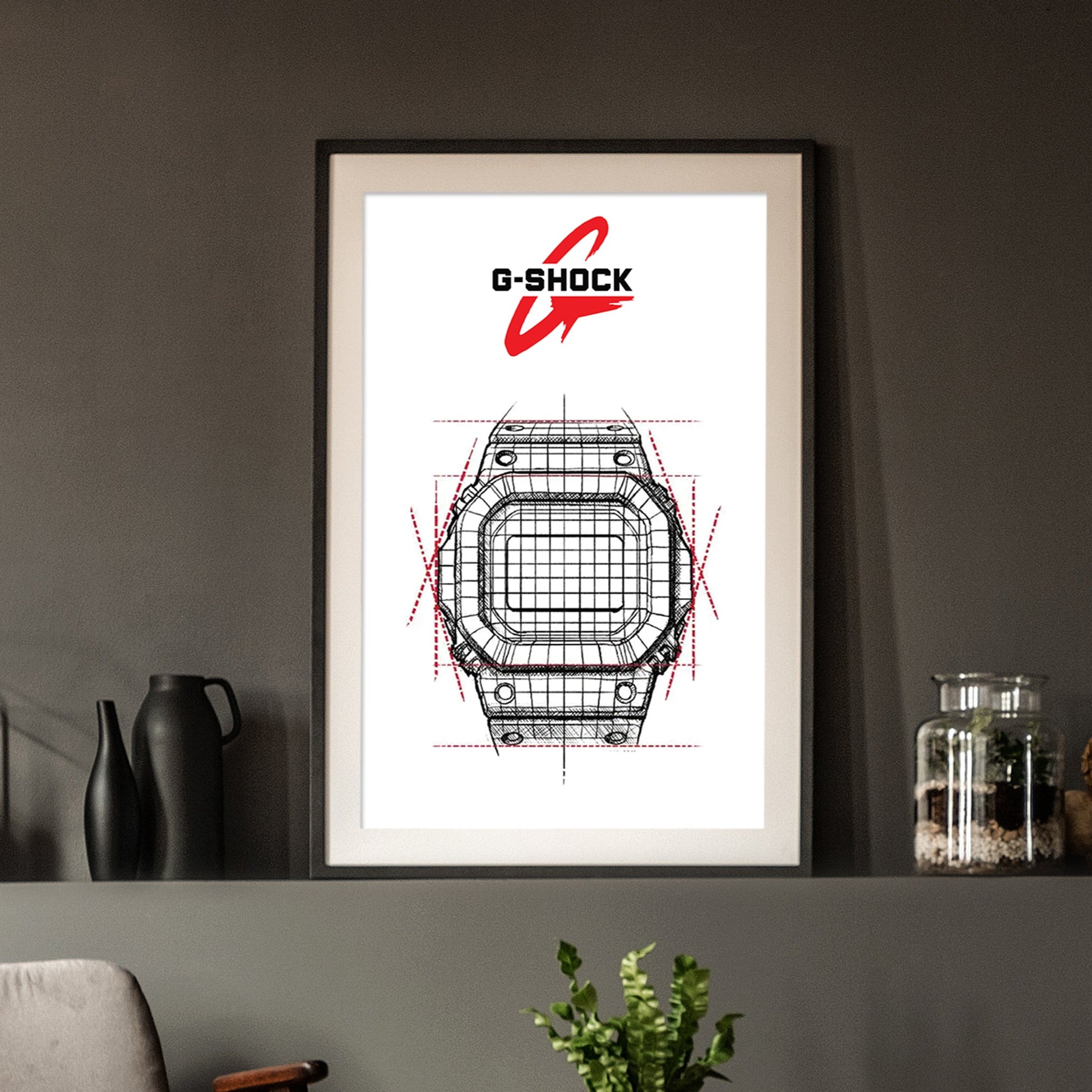 Framed G-Shock watch design art on a wall with decorative items.