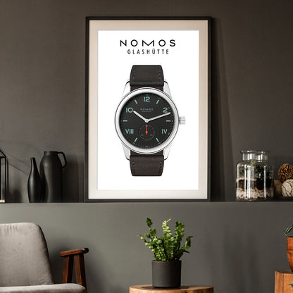 Framed poster of a Nomos Glashüte watch on a wall with decor elements.