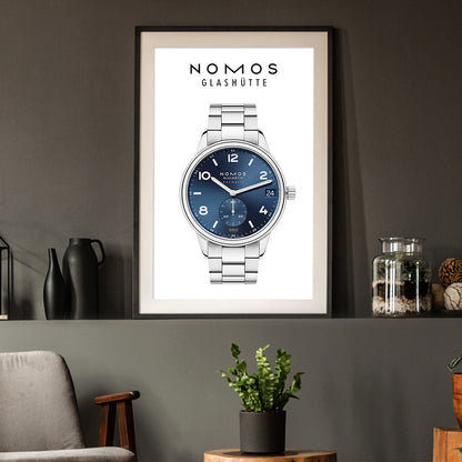 Framed poster of a Nomos Glashüte watch on a wall with decorative items.