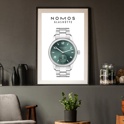 Framed poster of a Nomos Glashüte watch on a wall with decorative items.